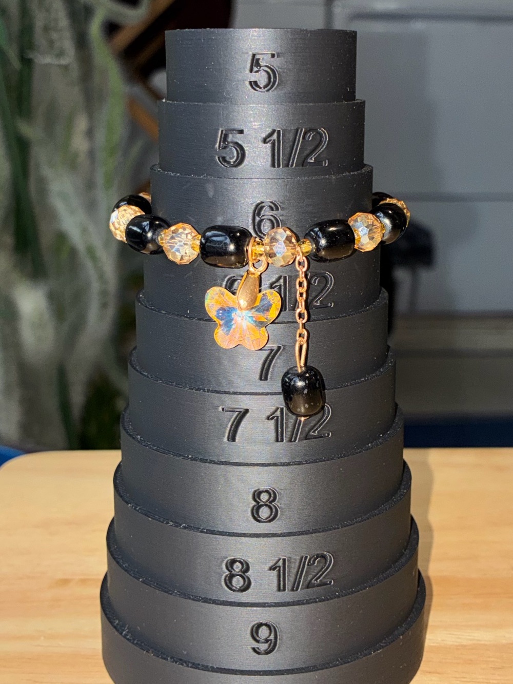 Black and Gold Beaded Stretch Bracelet with Iridescent Flower Charm - Picture 8 of 9